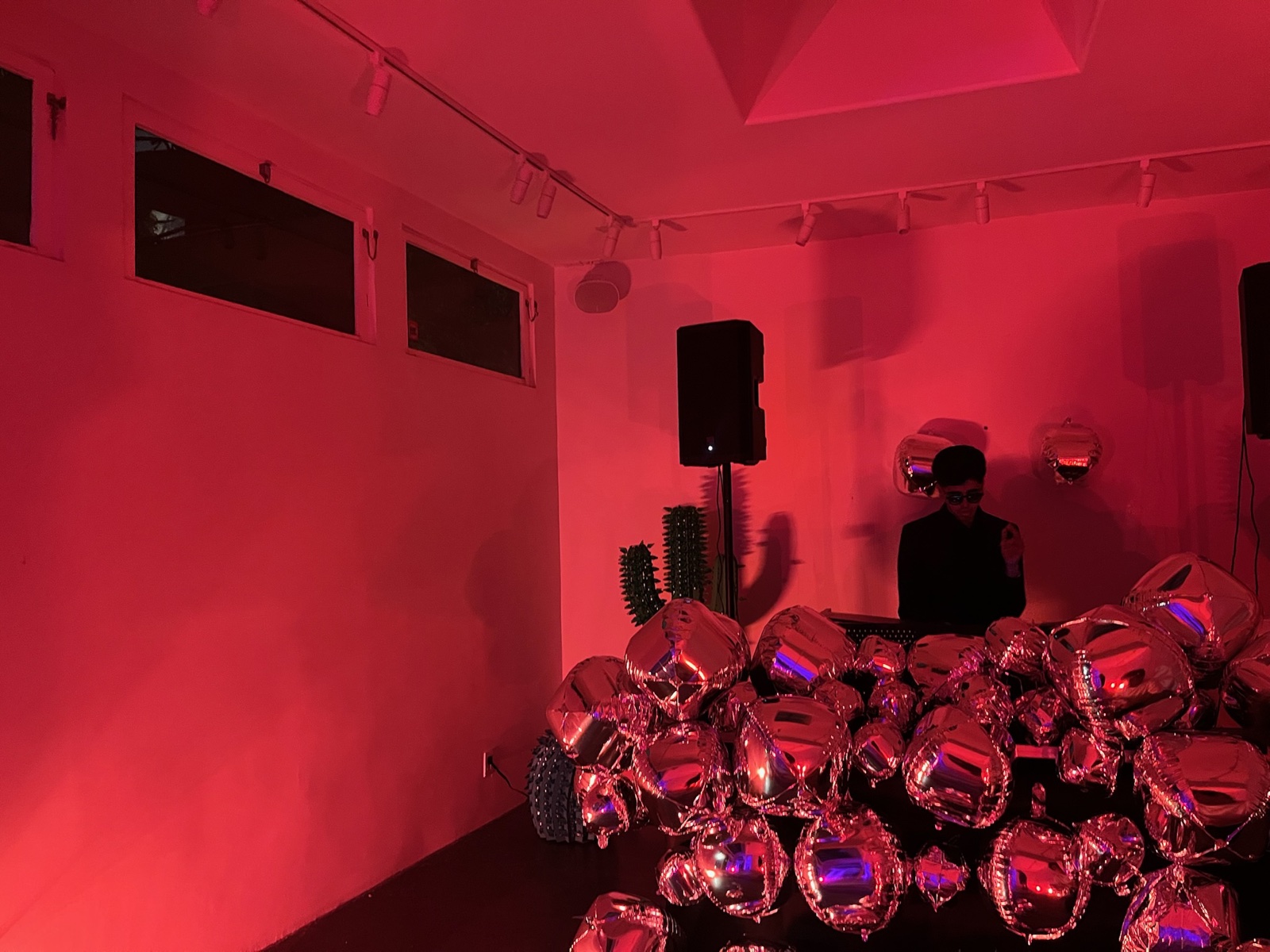 DJing behind a wall of balloons at a USC graduation party